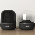 Harman Kardon Two Speakers With Black And Transparent Dome Designs On Wooden Tabletop