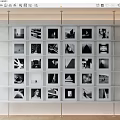 Black and White Photos Arranged on White Display Shelf Gallery Wall