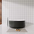 Modern Black Round Bathtub In Bathroom With White Vertical Striped Tile Wall And Metal Faucet