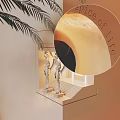 Elegant Wall Lamp with Winged Statues Near Stairs and Arched Doorway and Palm Leaves
