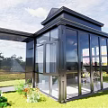 Black Framed Glass Sunroom With Interior Table Chairs And Exterior Grass Trees Blue Sky
