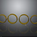 Four Shiny Gold Rings Arranged On Black Background With Reflections