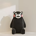 Black Bear Stuffed Doll With Pink Cheeks Sitting In Minimalist White Background With Shadow