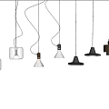 Various Designed Pendant Lights Hanging Against Rough Textured Wall Background