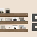 Photo Wall Featuring Beige Wall Three Wooden Shelves Displaying Books And Hanging Dark Frames