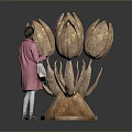 Large Bronze Tulip Sculpture Art Installation With Woman Viewing In Modern Space