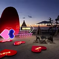 Outdoor Garden Decor Featuring Heart Shaped Neon Installations And LOVE Signs On Beach