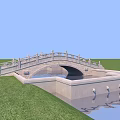 Stone Bridge With Arch Structure Over Water In Green Grass Field And Ornate Railings