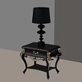 Elegant Black Nightstand With Gold Accents Ornate Legs And Decorative Lamp