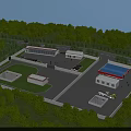 Industrial Factory Complex With Multiple Buildings Blue Roof Surrounding Greenery Trees Truck And Road