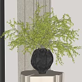 Stylish Black Textured Vase With Lush Green Foliage On White Pedestal Table