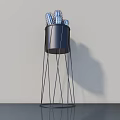 Modern Sculpture Carving With Blue Carved Pieces Black Cylindrical Container And Metal Wire Stand