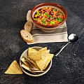 Fresh Homemade Mexican Food with Guacamole Corn Salad Sour Cream Tortilla Chips and Chili Stew