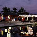 Commercial Street With Traditional Architecture Nighttime Lighting Waterfront And Pedestrians