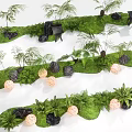 Green Shrub Landscaping With Moss Covered Ground Black Stones And Orange Orb Lights