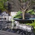 Natural Rockery Stones With Waterfall Green Plants Tree And Wooden Deck By Background Wall