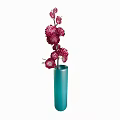 Elegant blue cylindrical vase holding several blooming pink flowers as home decor