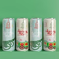 Four White Beverage Cans Featuring Red Green Decorative Arabic Script And Ornate Patterns