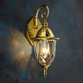 Golden Antique Wall Lamp With Glass Shade Illuminating Textured Dark Wall