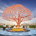 Artistic Outdoor Tree Installation With Orange Circular Canopy Swings People And Colorful Ground