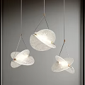 Three Modern Leaf Shaped Glass Pendant Lights With Gold Metal Frames Illuminated On Gray Wall