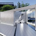 Modern Outdoor Sculpture In Stone Wall And Glass Structure Courtyard Setting