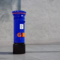 Blue Commercial Post Box With GR Logo Standing Against Brick Wall 3d model