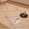 Beige Square Area Rug With Gold Lines Tray Cup And Magazine On Wooden Floor
