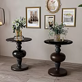 Elegant Black and Brown Side Tables with Spherical Bases Round Tabletops and Green Plant Vases