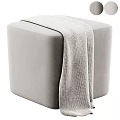 Light Gray Upholstered Ottoman with Soft Waffle Knit Blanket on Top