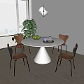 Modern Round Dining Table Set with White Conical Base Four Brown Chairs and Green Plant