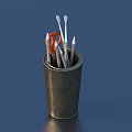 Pens Arranged In Metal Pen Holder With Orange Scissors On Blue Background