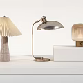 Elegant Table Lamps On White Display Stand With Pleated Shade Adjustable Arm And Frosted Glass