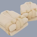 Two Folded Beige Bathrobes With Belt Tied Into Bow Against Light Blue Background