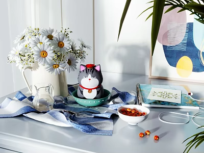 Decorative Ornament Collection with White Daisies Cat Figurine Blue Bowl Notebook and Striped Cloth on Table 3d model