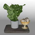 Chocolate Drizzled Dessert Scoops in Golden Bowl on Gray Stone Base with Green Leafy Plant