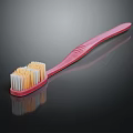 Pink Toothbrush With White And Yellow Bristles For Daily Oral Care