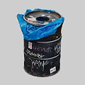 Old Black Barrel Covered With Blue Trash Bag And Graffiti