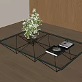 Modern Glass Coffee Table with Metal Frame Flower Vase and Books on Wooden Floor