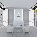Modern CANDISTAR Showroom Displaying Home Appliances And Various Products With Central White Exhibition Counter
