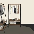 Two Clothes Racks With Hanging Shirts Dresses And Shelves Holding Storage Bags Baskets