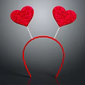 Red Decorative Headband With Two Sparkly Heart Shaped Ornaments on Gray Background