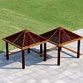 Two Wooden Pergolas with Pyramid Roof Structure on Stone Pavement and Green Grass