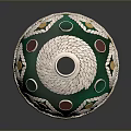 Green And Silver Decorative Container With Ornate Curved Patterns And Colorful Dots