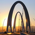 Modern White Arch Bridge With Cable Stay Design Over River And Blue Sky