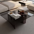 Modern Glass Top Coffee Table with Black Frame Decorative Tray and Books in Living Room