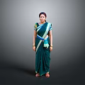 Woman In Green Saree With Blue Yellow Accents And Bangles Against Grey Background