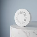 White Circular Commercial Equipment With Perforated Design On Marble Surface And Light Blue Backdrop