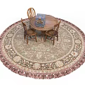 Round Fringed Area Rug With Wooden Table Blue Box And Three Chairs