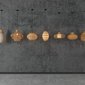 Various Woven Pendant Lights In Natural Color Hanging On Textured Gray Wall